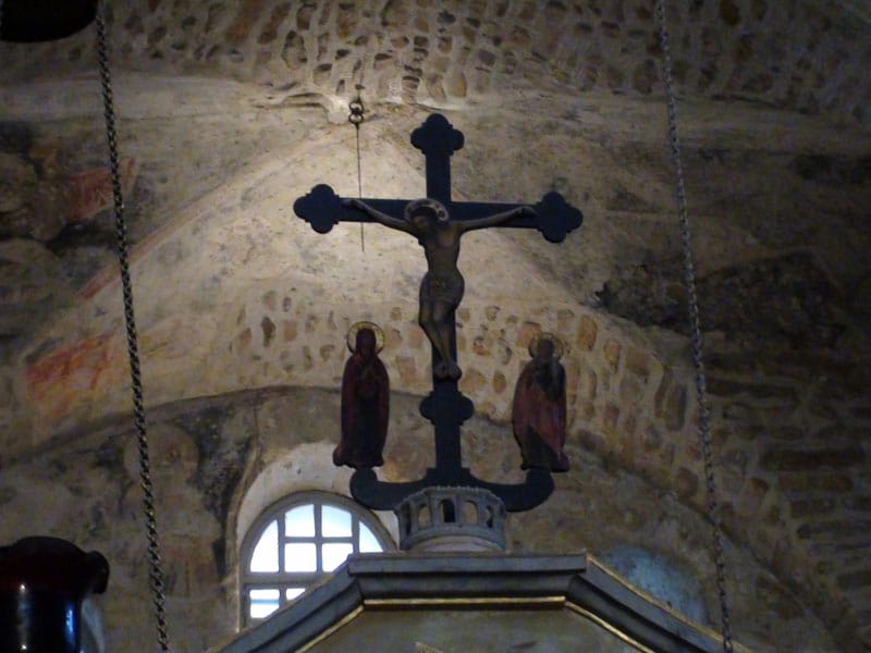 An old cross on top of the templon